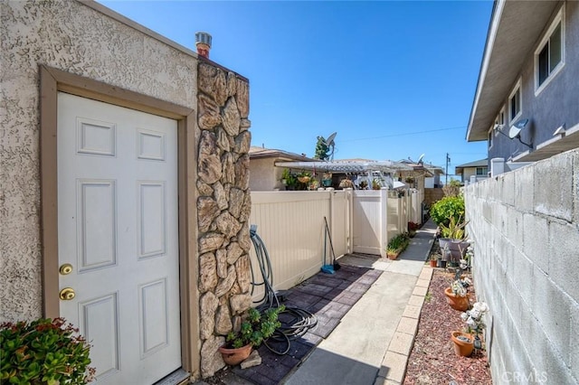 view of property exterior featuring a patio, a fenced backyard, and stucco siding