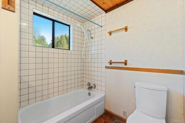 bathroom with toilet and bathtub / shower combination