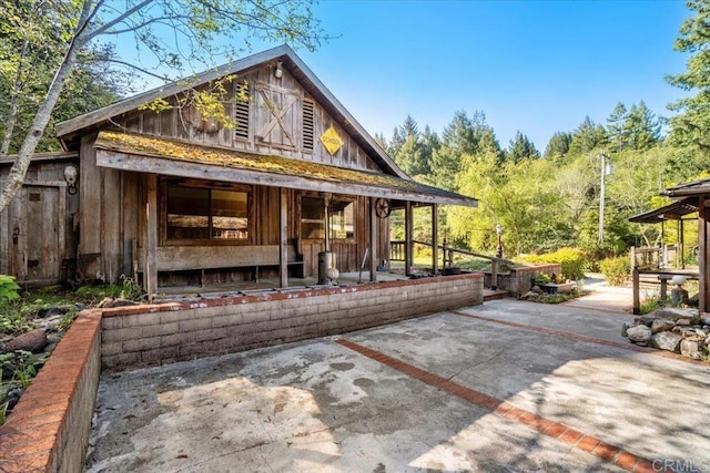 rear view of house featuring board and batten siding