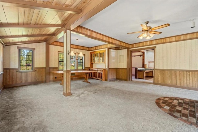 interior space featuring wood walls, wainscoting, and carpet floors