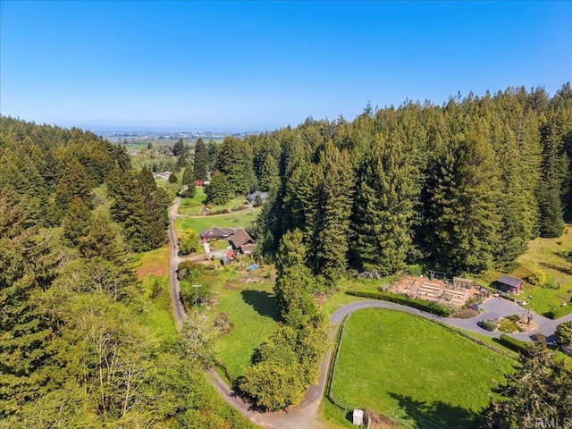 bird's eye view featuring a wooded view
