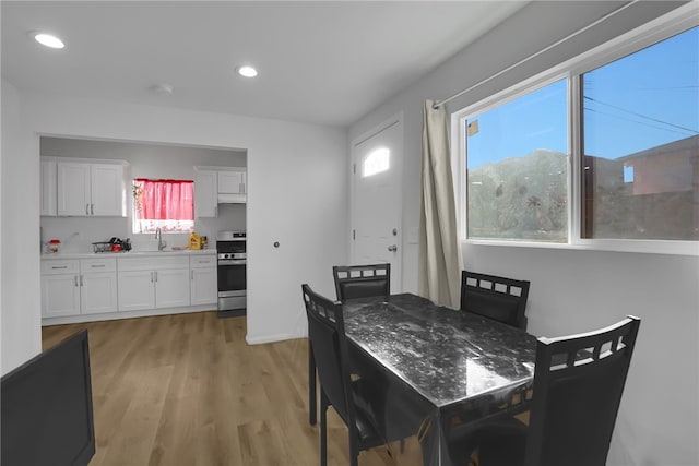dining area featuring recessed lighting and light wood-style floors