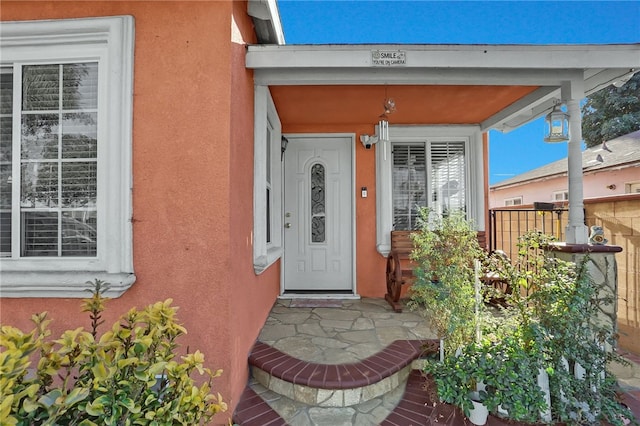 view of exterior entry with stucco siding