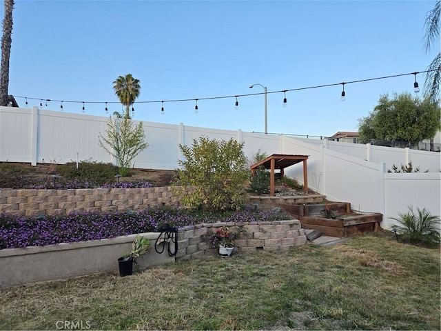 view of yard featuring a vegetable garden and a fenced backyard
