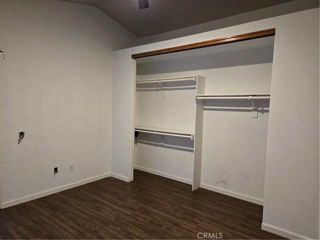 unfurnished bedroom with vaulted ceiling, wood finished floors, a closet, baseboards, and ceiling fan
