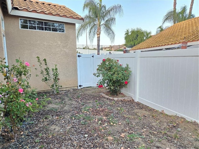 view of yard featuring fence and a gate