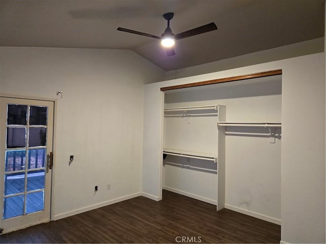 unfurnished bedroom with baseboards, vaulted ceiling, wood finished floors, and a closet