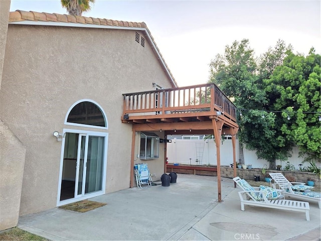 view of patio with fence and a deck