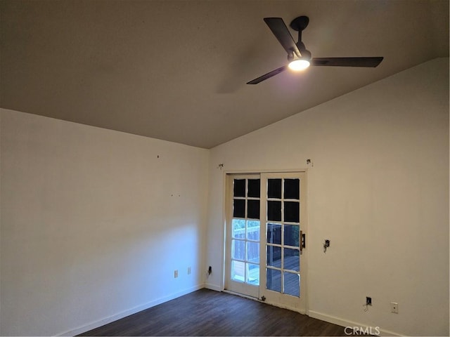 spare room featuring ceiling fan, lofted ceiling, dark wood-style floors, and baseboards