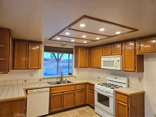 kitchen featuring a sink, recessed lighting, white appliances, open shelves, and tile counters
