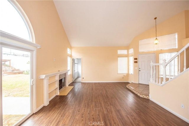 24356 Via Las Junitas, Murrieta, CA 92562 - unfurnished living room with baseboards, high vaulted ceiling, wood finished floors, and a high end fireplace