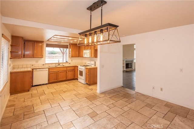 24356 Via Las Junitas, Murrieta, CA 92562 - kitchen with brown cabinetry, open shelves, a sink, stone tile flooring, and white appliances
