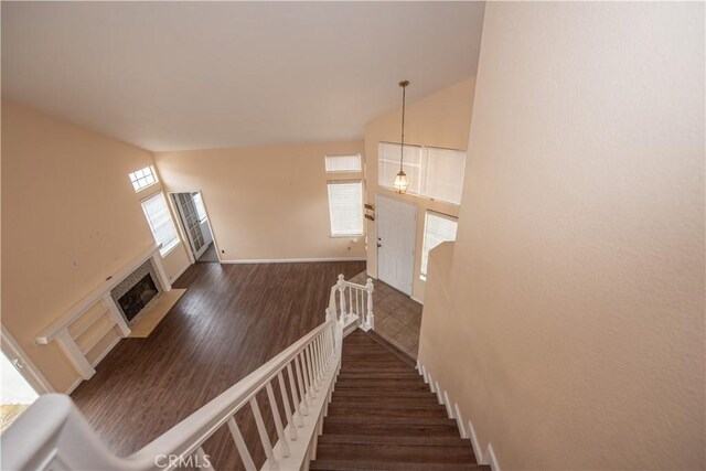 24356 Via Las Junitas, Murrieta, CA 92562 - stairs featuring baseboards, a tile fireplace, wood finished floors, and lofted ceiling