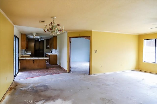 32157 Navajo Ct, Coarsegold, CA 93614 - kitchen with open floor plan, ceiling fan with notable chandelier, and tile counters