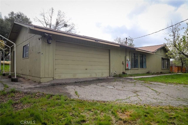 32157 Navajo Ct, Coarsegold, CA 93614 - view of side of property with a garage and aphalt driveway