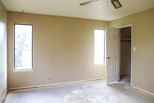 32157 Navajo Ct, Coarsegold, CA 93614 - unfurnished bedroom featuring multiple windows, baseboards, and a ceiling fan