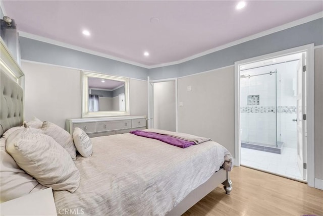 bedroom featuring ornamental molding, recessed lighting, ensuite bathroom, and wood finished floors