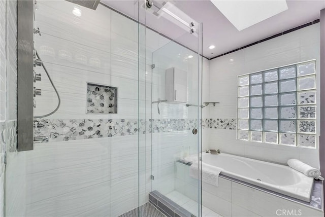 bathroom with a shower stall and a bath