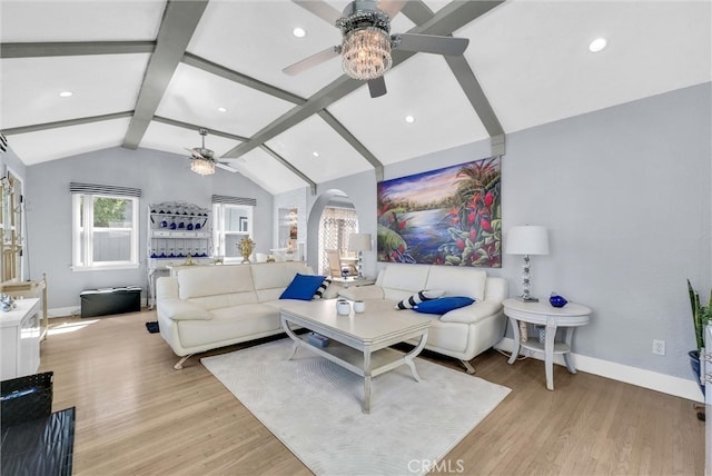 living room with baseboards, lofted ceiling with beams, a ceiling fan, arched walkways, and light wood finished floors