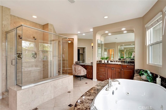 full bath featuring tile patterned floors, recessed lighting, a jetted tub, a shower stall, and vanity
