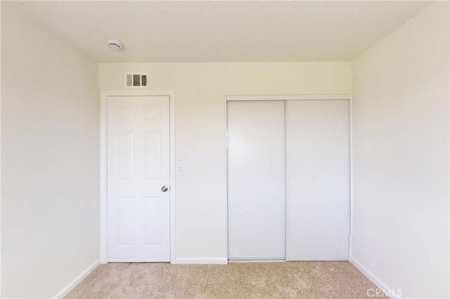 830 E Darlan St, Compton, CA 90220 - unfurnished bedroom featuring a closet, baseboards, visible vents, and light colored carpet