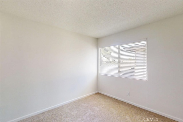 830 E Darlan St, Compton, CA 90220 - unfurnished room featuring light carpet, baseboards, and a textured ceiling