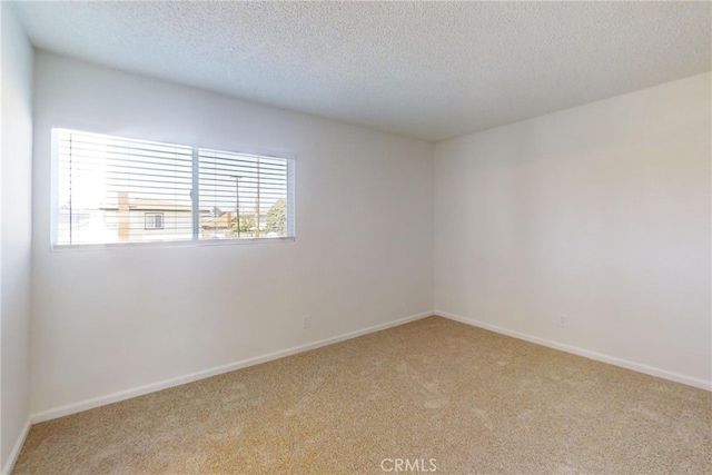 830 E Darlan St, Compton, CA 90220 - empty room with carpet floors, a textured ceiling, and baseboards
