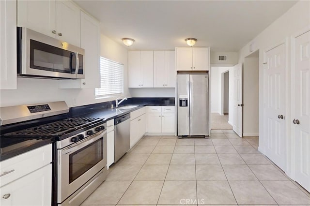 830 E Darlan St, Compton, CA 90220 - kitchen featuring dark countertops, visible vents, a sink, and appliances with stainless steel finishes