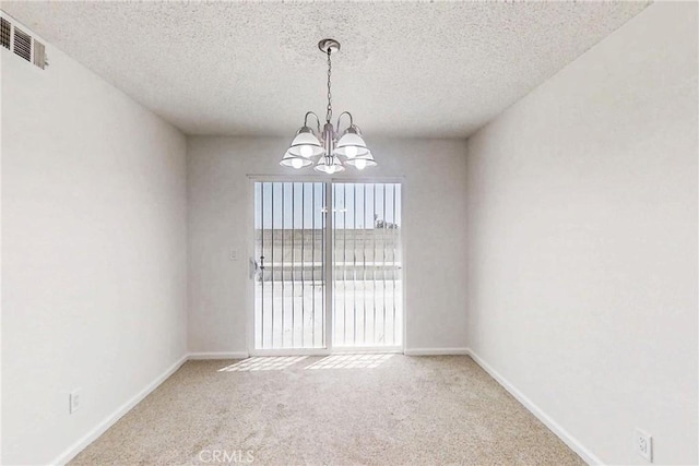 830 E Darlan St, Compton, CA 90220 - empty room with carpet, visible vents, baseboards, a textured ceiling, and a notable chandelier