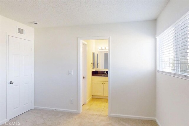 830 E Darlan St, Compton, CA 90220 - unfurnished bedroom with visible vents, baseboards, light carpet, and connected bathroom