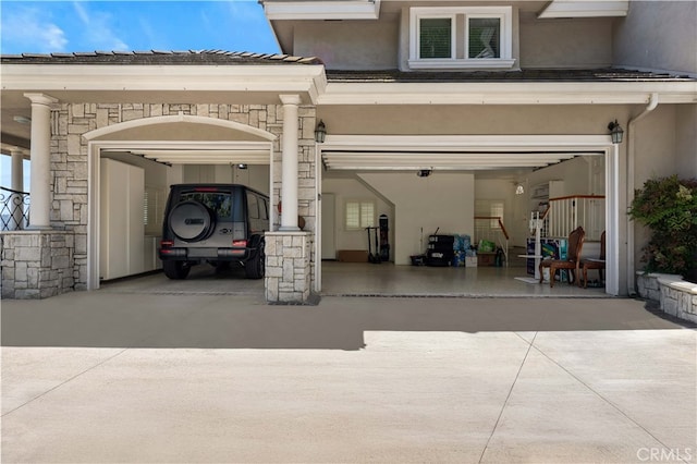 garage featuring concrete driveway