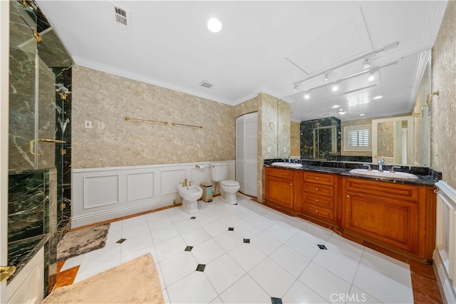 bathroom with a shower stall, a bidet, double vanity, wainscoting, and ornamental molding