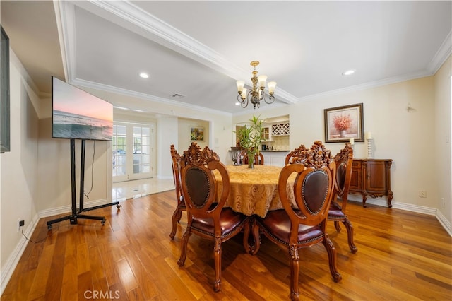 dining room featuring a chandelier, wood finished floors, baseboards, ornamental molding, and recessed lighting