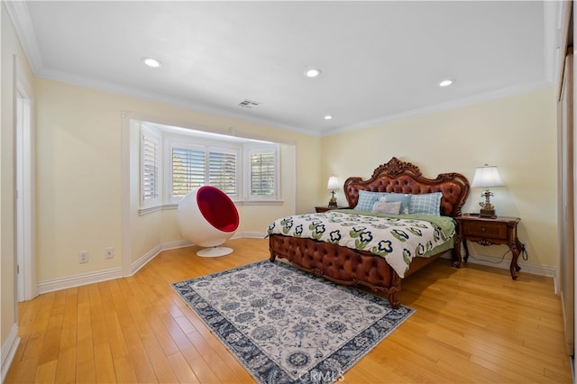bedroom featuring light wood-type flooring, ornamental molding, baseboards, and recessed lighting