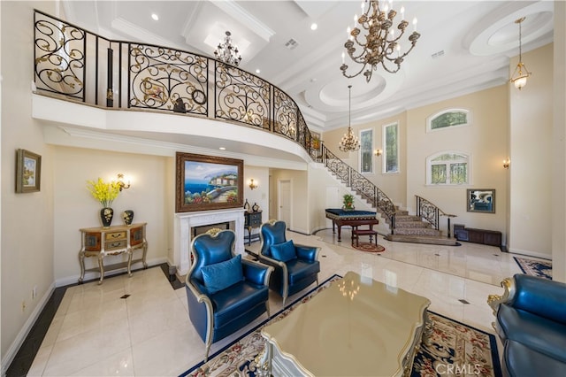 building lobby with ornamental molding, a towering ceiling, stairs, and recessed lighting