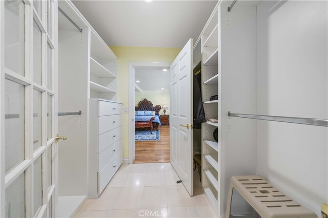 spacious closet featuring light tile patterned floors