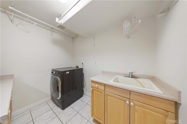washroom featuring washer / clothes dryer, light tile patterned floors, cabinet space, and baseboards