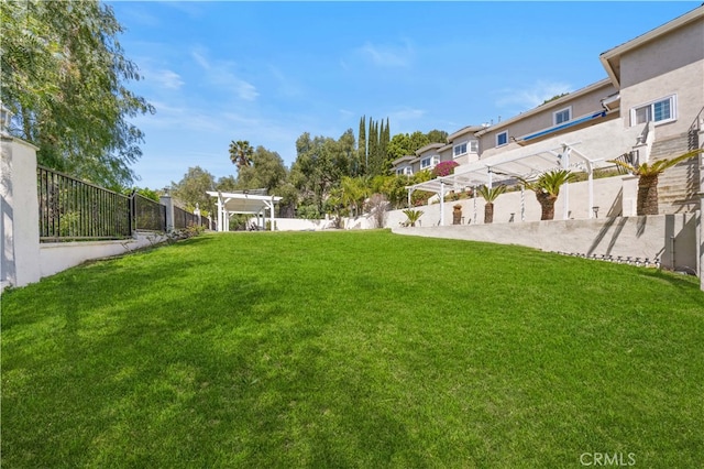 view of yard with a pergola and a residential view