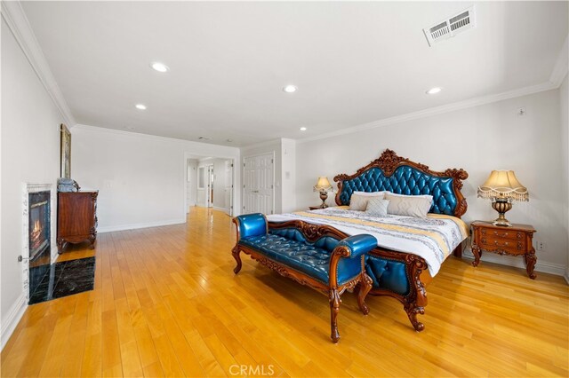 24106 Lodge Pole Rd, Diamond Bar, CA 91765 - bedroom featuring light wood-type flooring, baseboards, crown molding, recessed lighting, and a high end fireplace