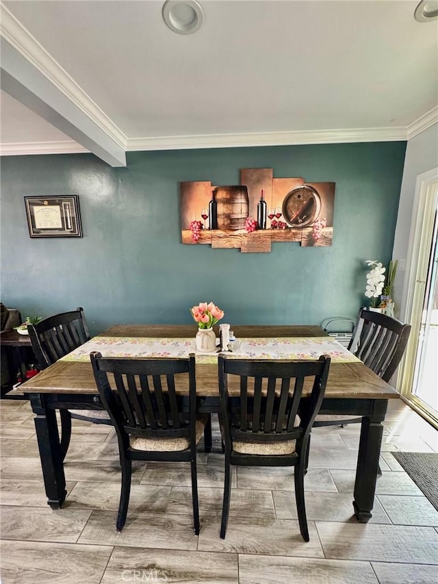dining area featuring crown molding and wood finish floors