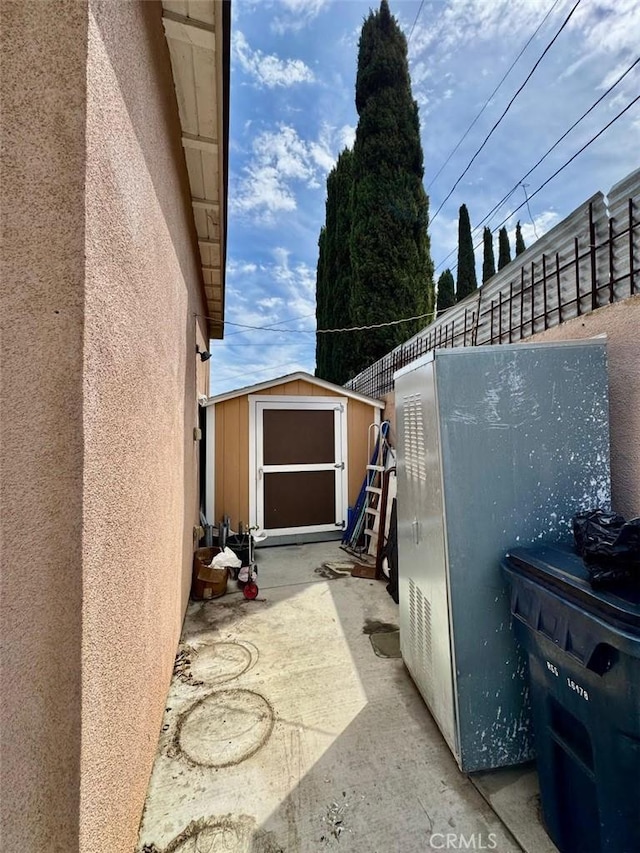 exterior space featuring a storage shed and an outbuilding