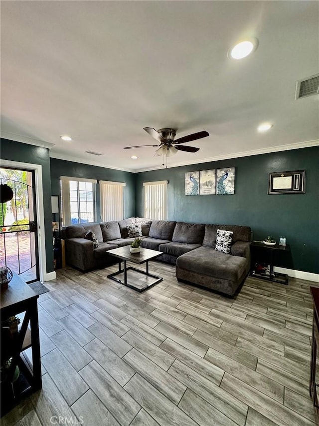 living room with baseboards, recessed lighting, crown molding, visible vents, and wood tiled floor