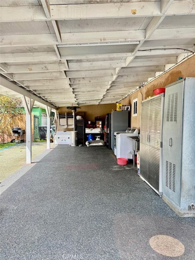 garage featuring freestanding refrigerator and washer / dryer