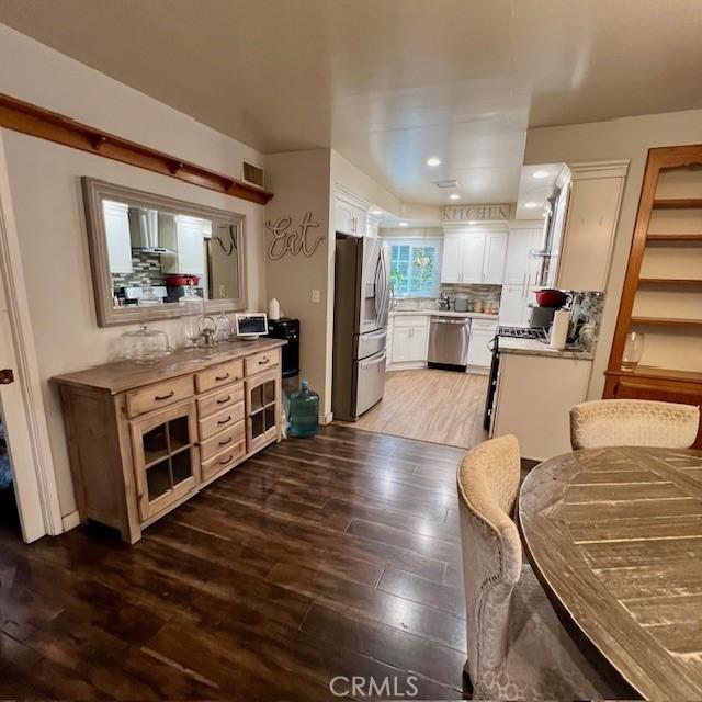 11406 Christy Ave, Sylmar, CA 91342 - kitchen featuring appliances with stainless steel finishes, light wood finished floors, white cabinets, light countertops, and recessed lighting
