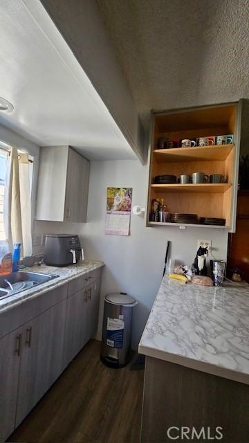 11406 Christy Ave, Sylmar, CA 91342 - kitchen with light countertops, dark wood finished floors, open shelves, and a sink