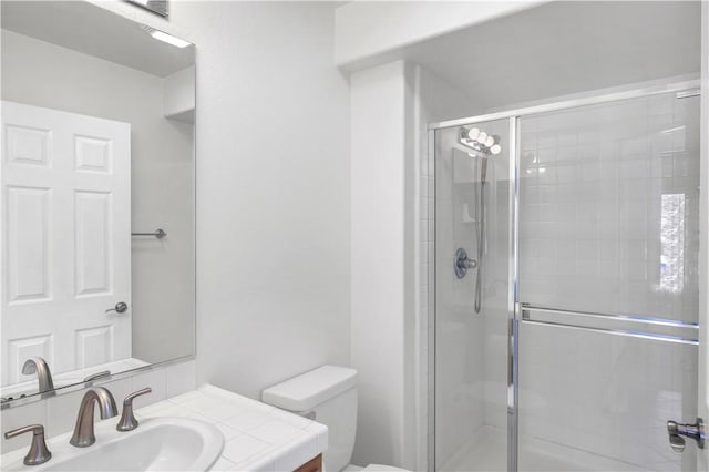 full bathroom with vanity, toilet, and a stall shower