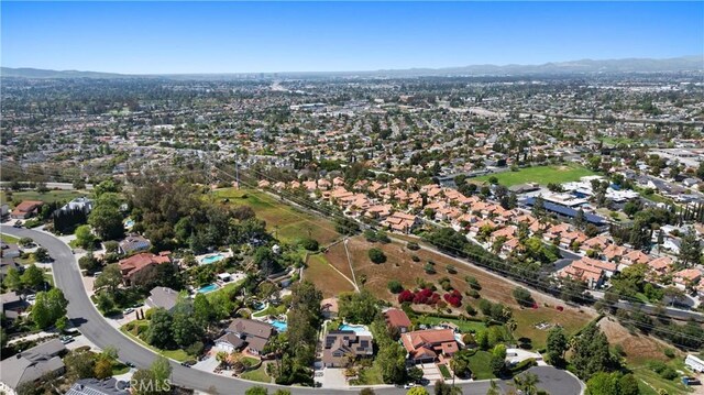 birds eye view of property featuring a mountain view and a residential view