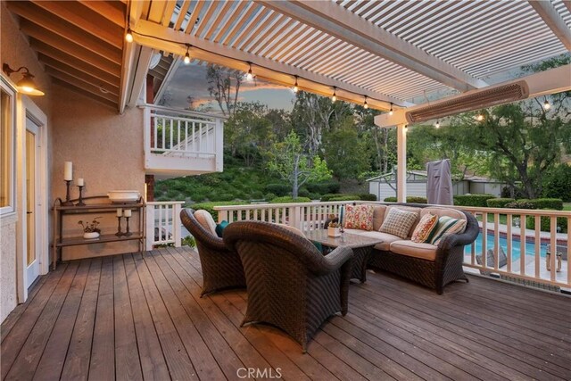 deck with a pergola, an outdoor pool, and an outdoor hangout area