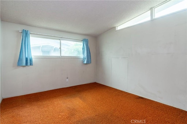 spare room featuring carpet floors and a textured ceiling