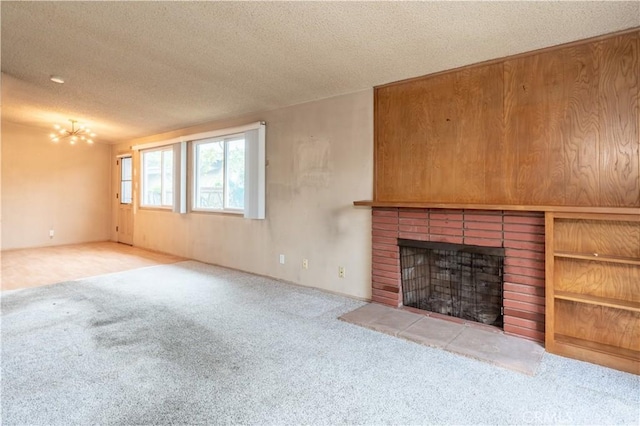 unfurnished living room featuring a fireplace, carpet, and a textured ceiling